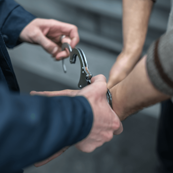 Someone being handcuffed by a cop