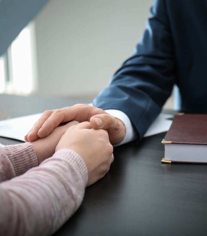 An attorney offering comfort to a woman.