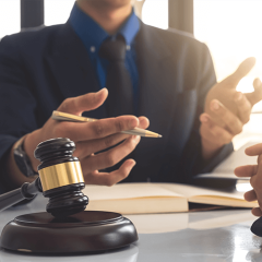 Attorney explaining to his client with pen in his hand