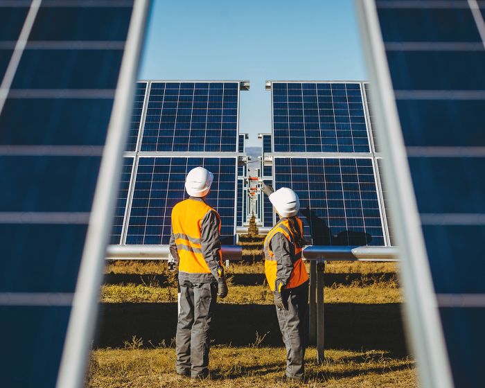 Workers looking at solar panels.