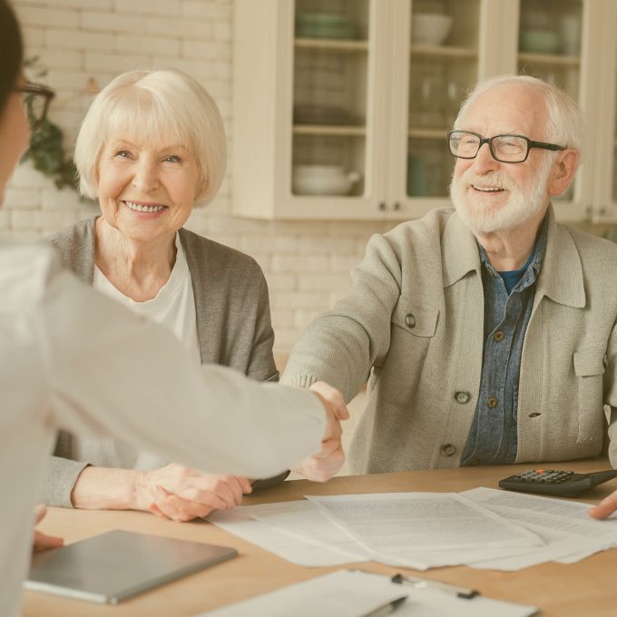 Happy old elderly senior grandparents family couple clients signs financial insurance