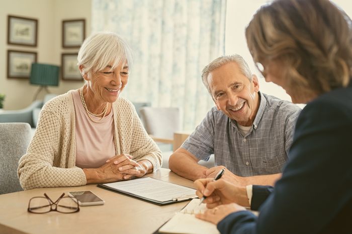 Senior couple consulting with financial agent