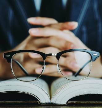 glasses resting on open book