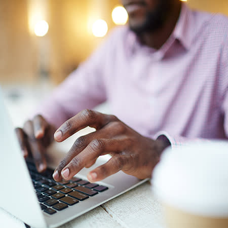 man typing on a computer