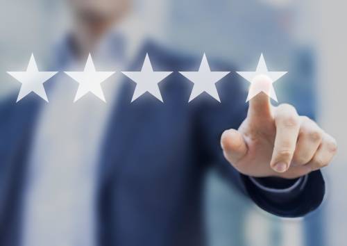 Businessman touching screen with 5 stars