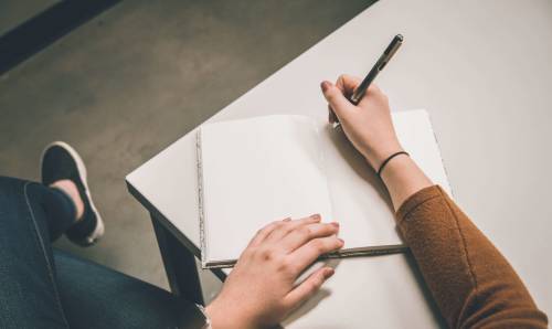 Woman writing in a notebook