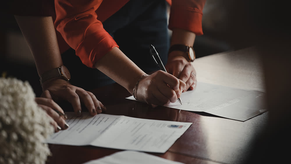 People signing documents