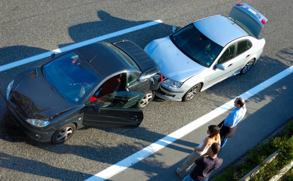 People standing by car accident