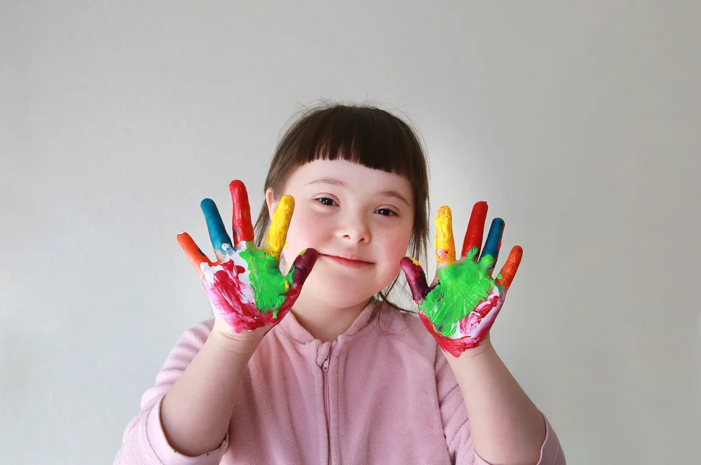 Little girl with paint covering her hands