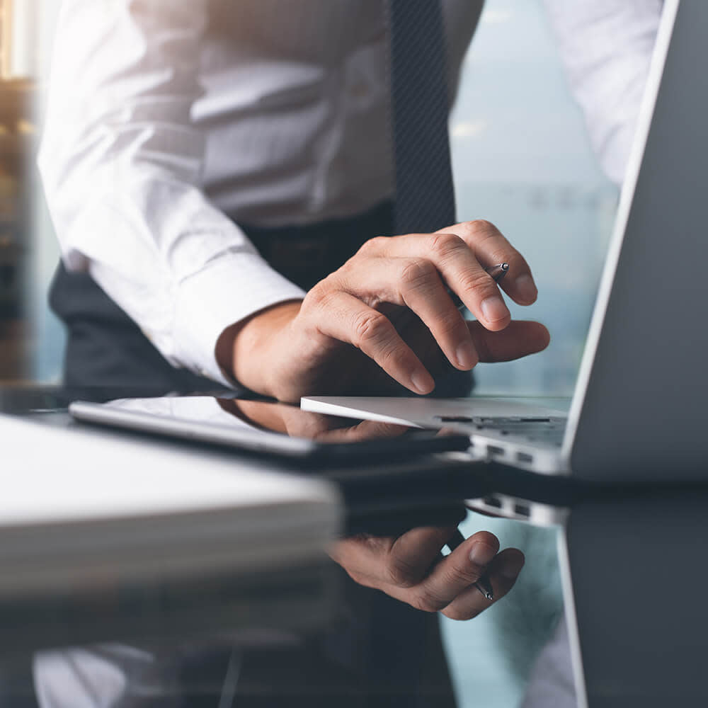 Businessman typing at a computer