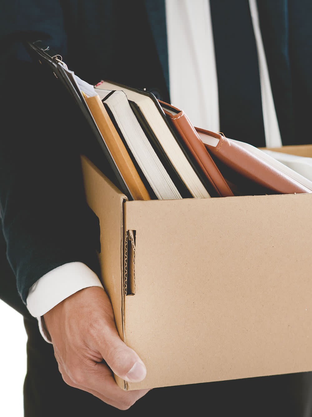 Businessman holding a box of belongings