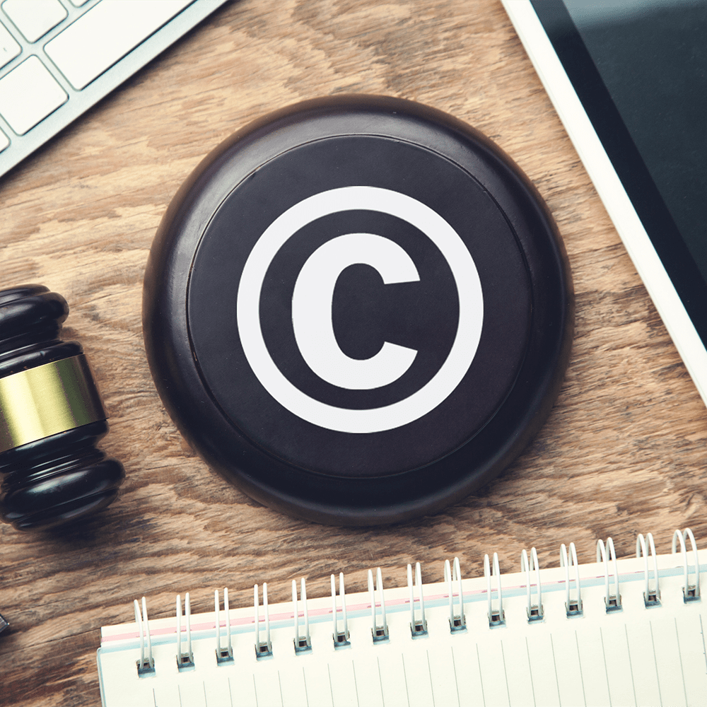 Judge gavel with tablet. Copyright. Intellectual Property