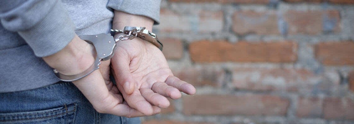 a man with his hands cuffed behind his back.jpg