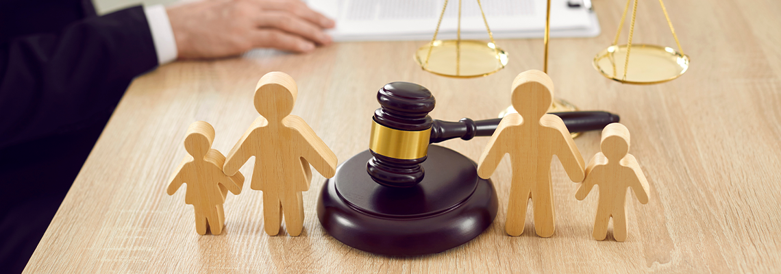 Figures of family are separated by judge's gavel