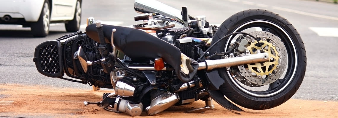 Damaged motorcycle on road after accident