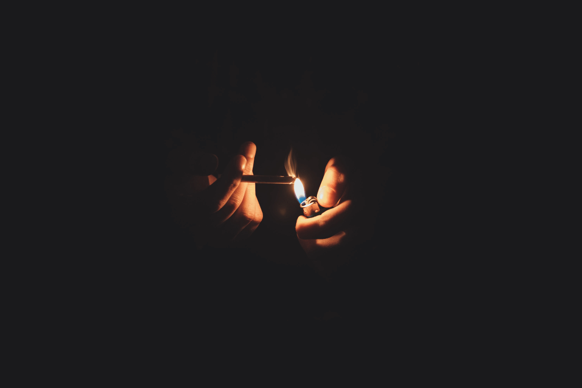lighting up a cigarette in the dark