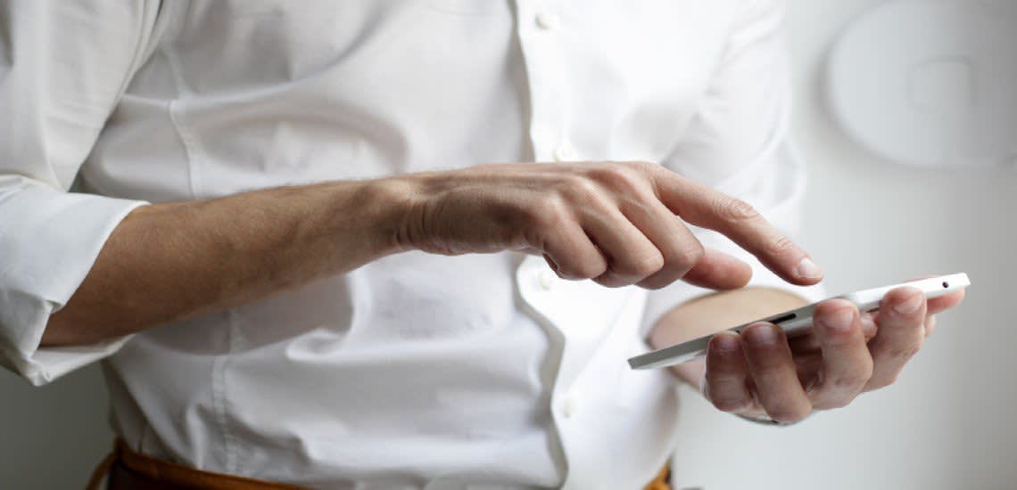 Person in white shirt texting