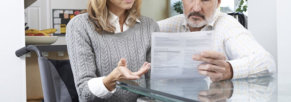 A man and woman look over a document
