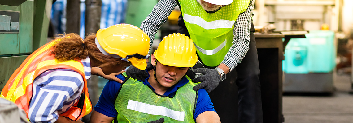 worker in helmet on ground in industrial factory
