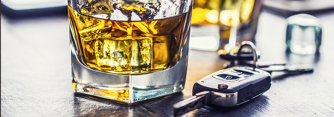 Car keys and glass of alcohol