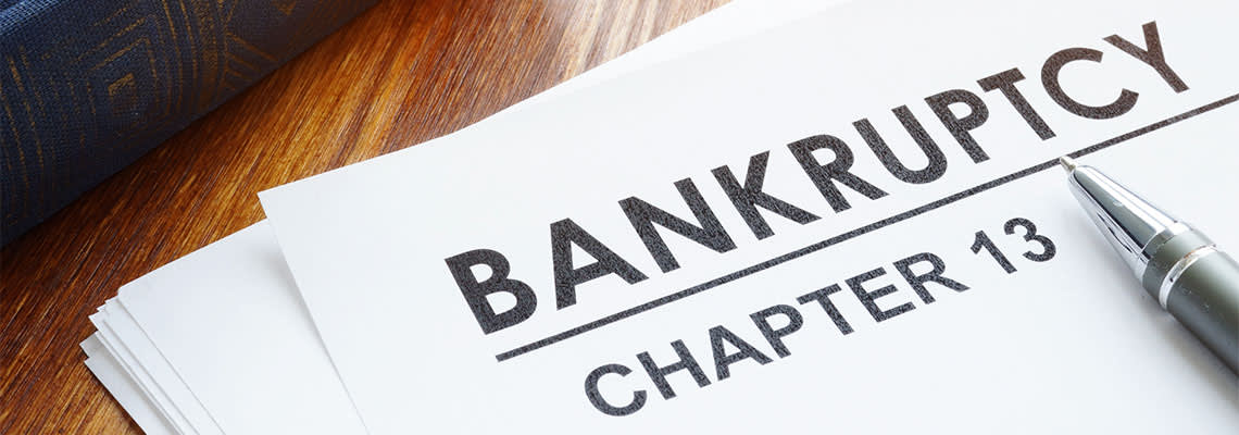 Chapter 13 Bankruptcy file and pen on table