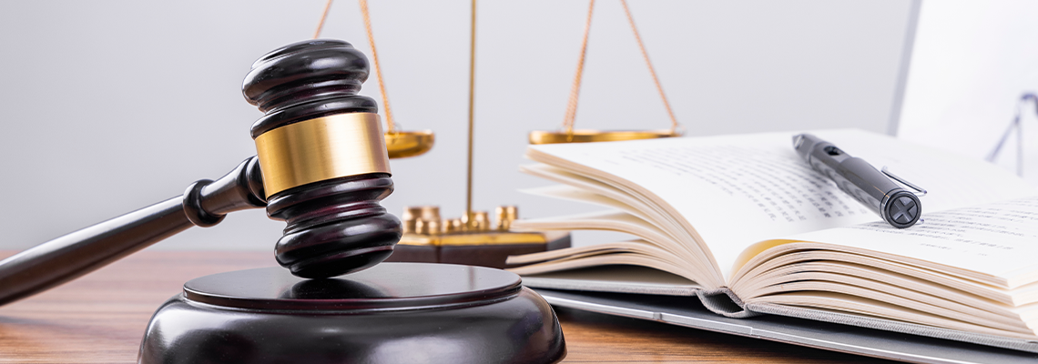 Judge's hammer and scale on the table with law book
