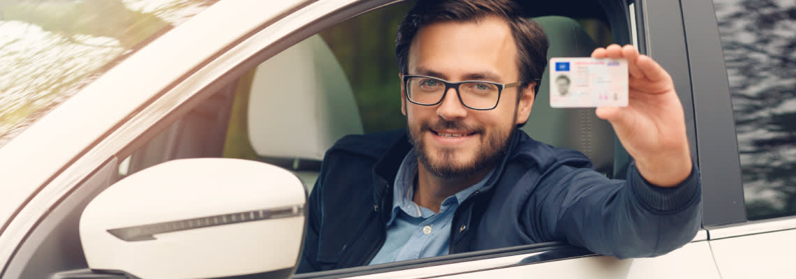 Man showing his driving license