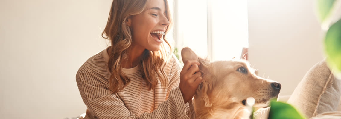 Women with pet dog in home