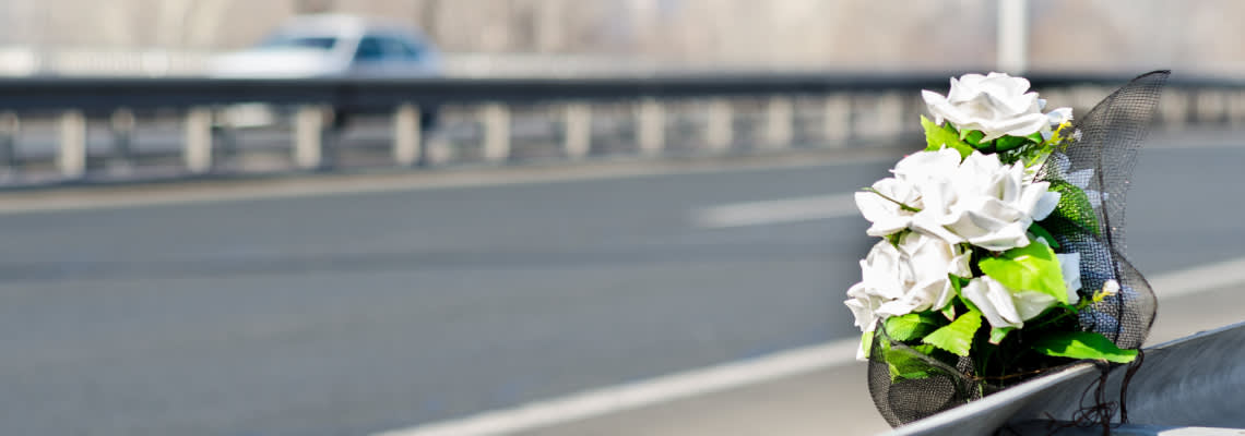 White flowers on road symbolizing road accident death