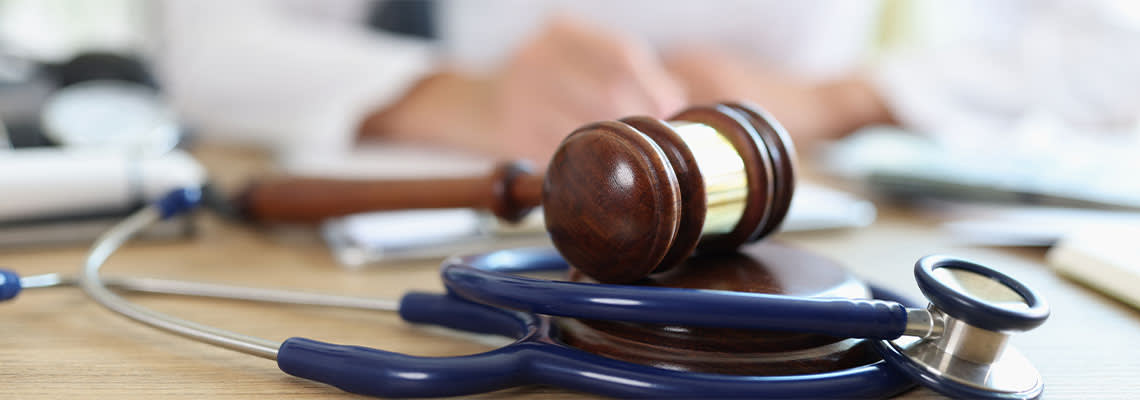 Gavel and Stethoscope in table