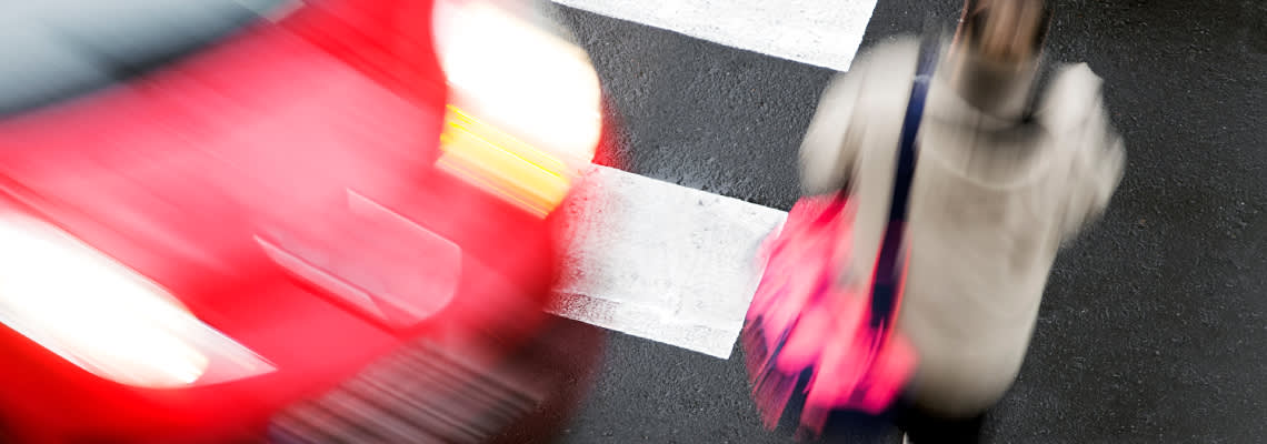 Car about to collide with pedestrian in crosswalk