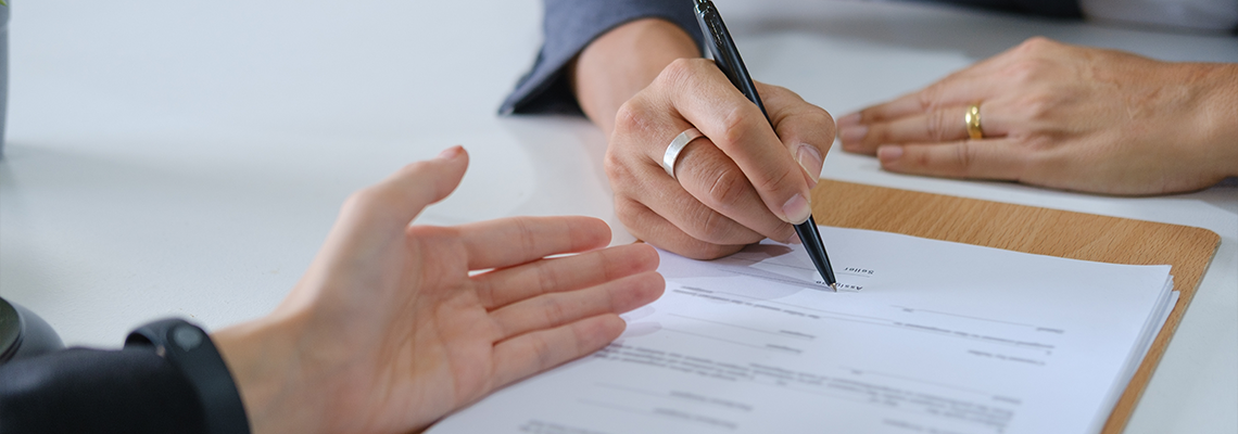 Close up of business people reviewing a contract agreement