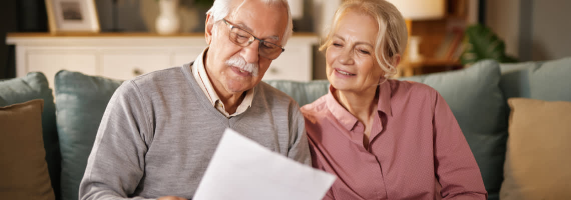 Senior couples reading their will document
