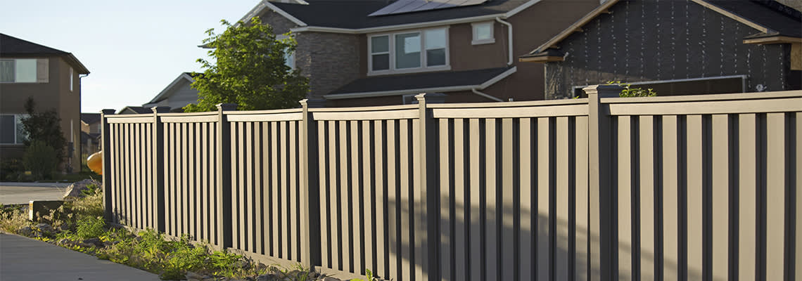 Shot of fence around a house in a neighborhood