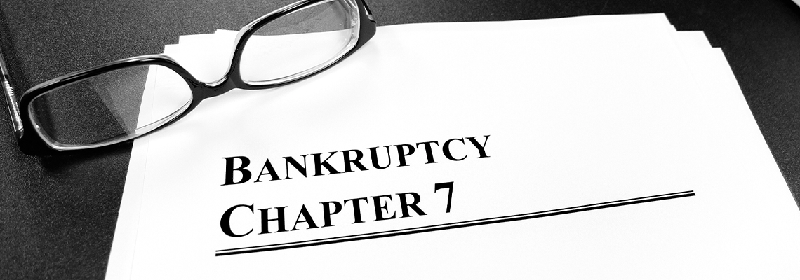 Bankruptcy Chapter 7 Documents on Desk with Glasses