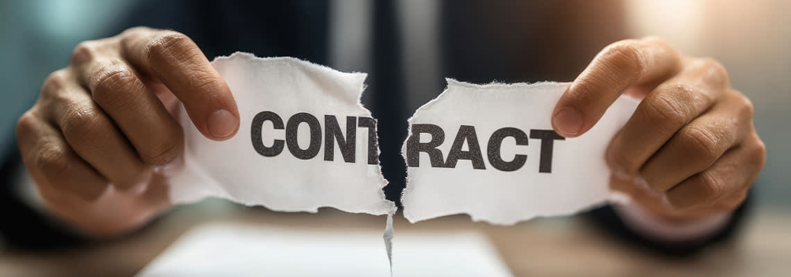 Businessman tear paper with word contract