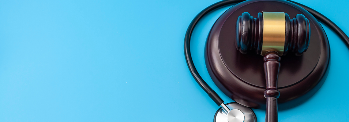 Medical malpractice concept with gavel and stethoscope
