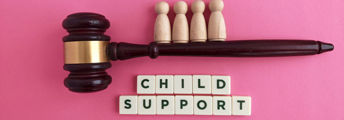 Gavel with wooden figures representing child support concept