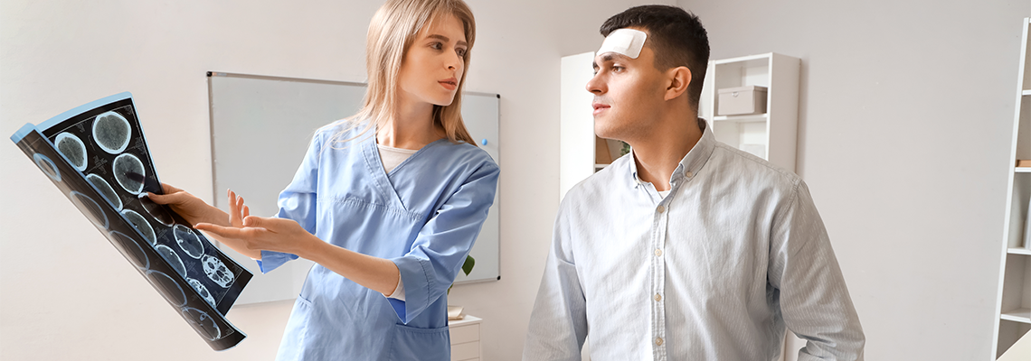 Female doctor and man with brain concussion examining MRI scan