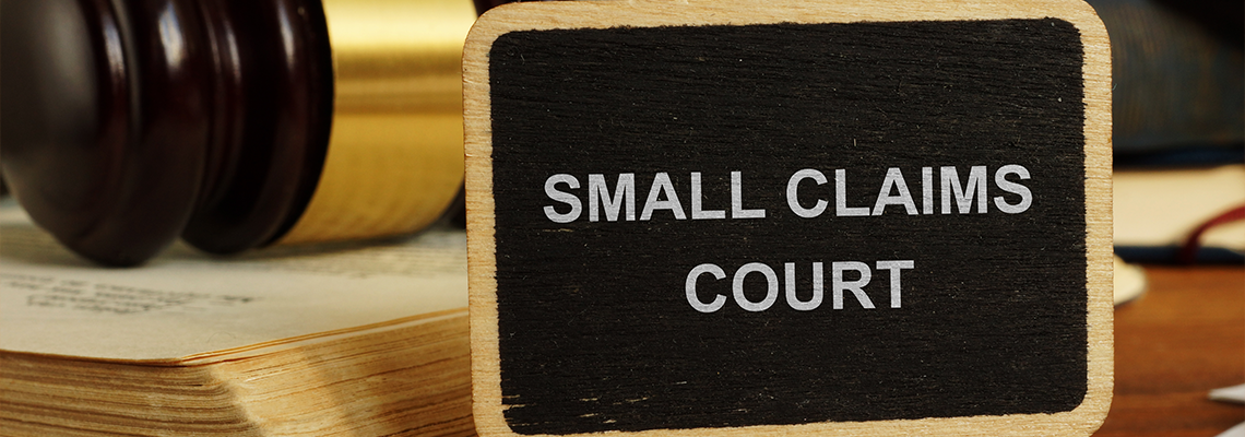 Text sign showing hand written words small claims court
