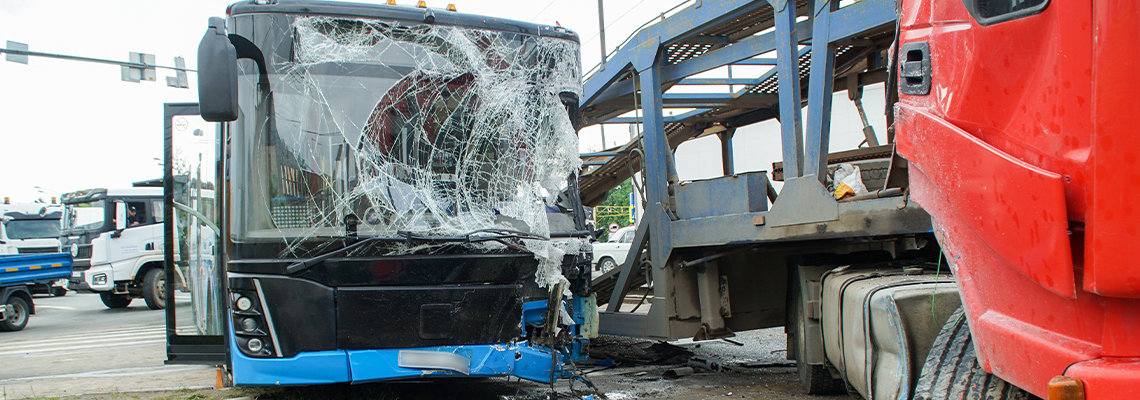 Collision between a bus and a car transporter