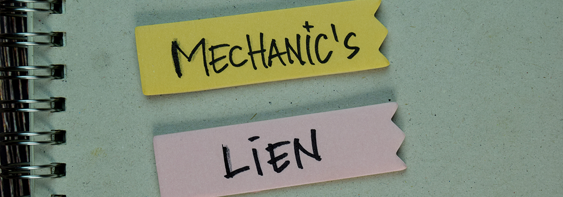 Mechanic's Lien write on a book isolated on Wooden Table