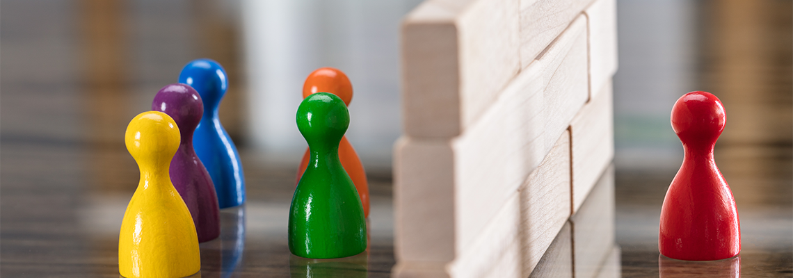 Red And Blue Figurine Paw Separated By Wooden Blocks