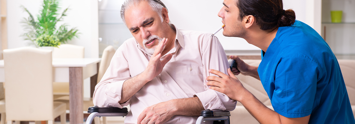 Old man in wheel-chair and young bad caregiver indoors