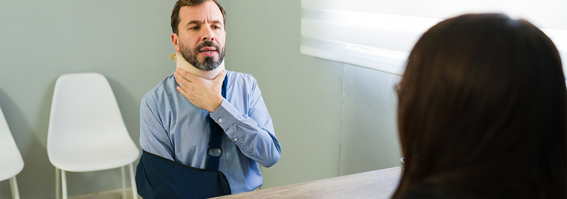 Injured client discussing accident insurance claim with agent