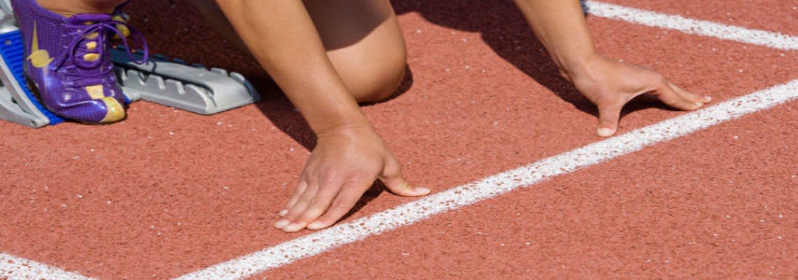 athlete in the starting block gets ready to race