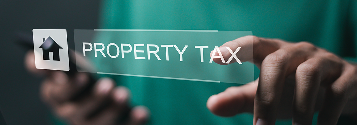 Person use laptop with property tax and house icon