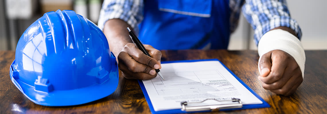 Injured worker filling in compensation form
