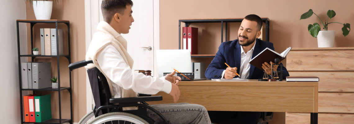 Man in wheelchair consulting with an attorney
