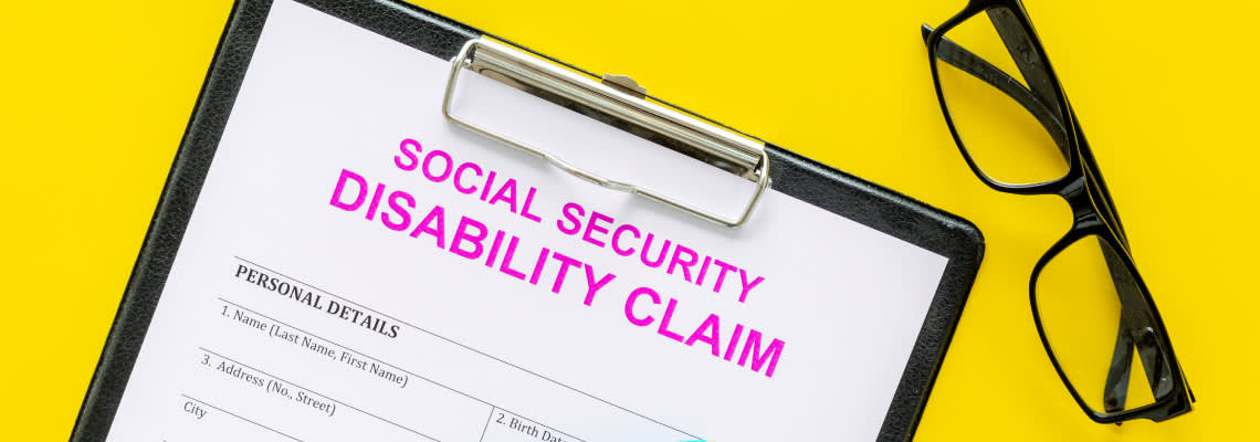 Social security Disability claim form near pen and glasses